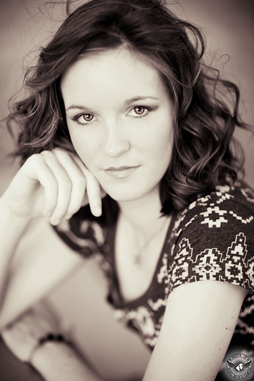 Best seniors portraits Austin of demure young women with curly hair at Mueller Lake Park.