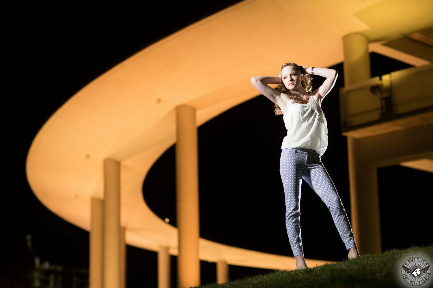 Austin senior portraits at the Long Center at night of blonde girl at night.