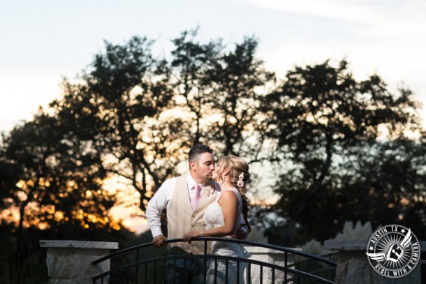 Romantic wedding pictures at The Springs Events in Georgetown, Texas - Gabriel Springs - bride and groom kiss on bridge